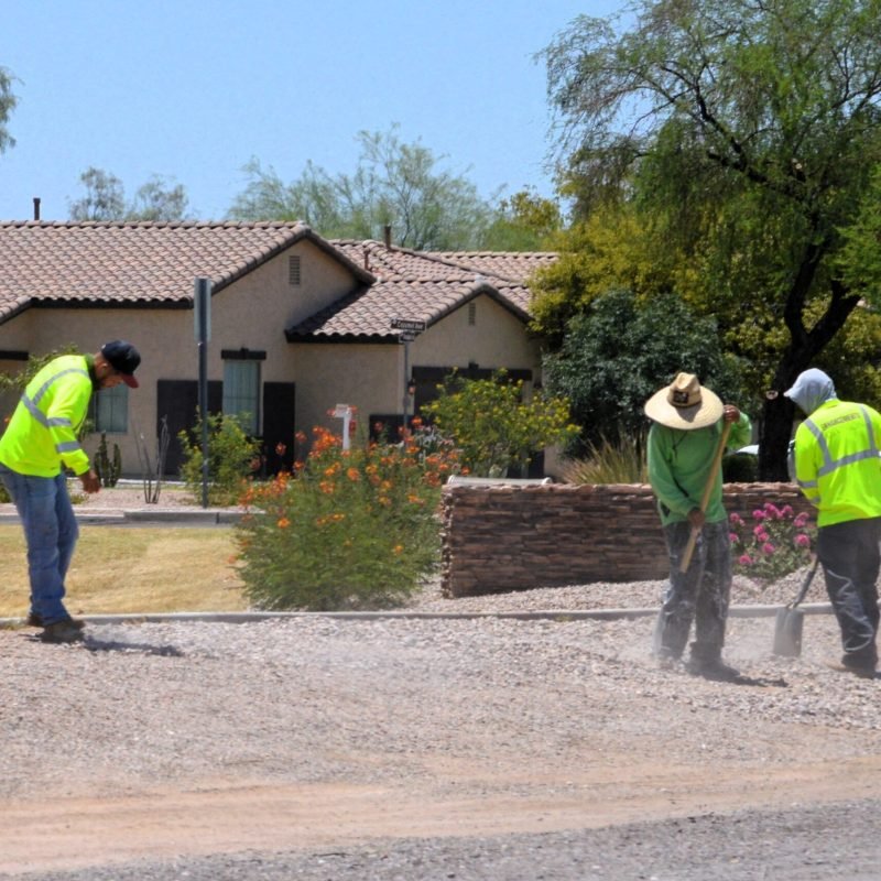 Construction,Workers,Landscaping,In,Residential,Neighborhood,On,Hot,Sunny,Day